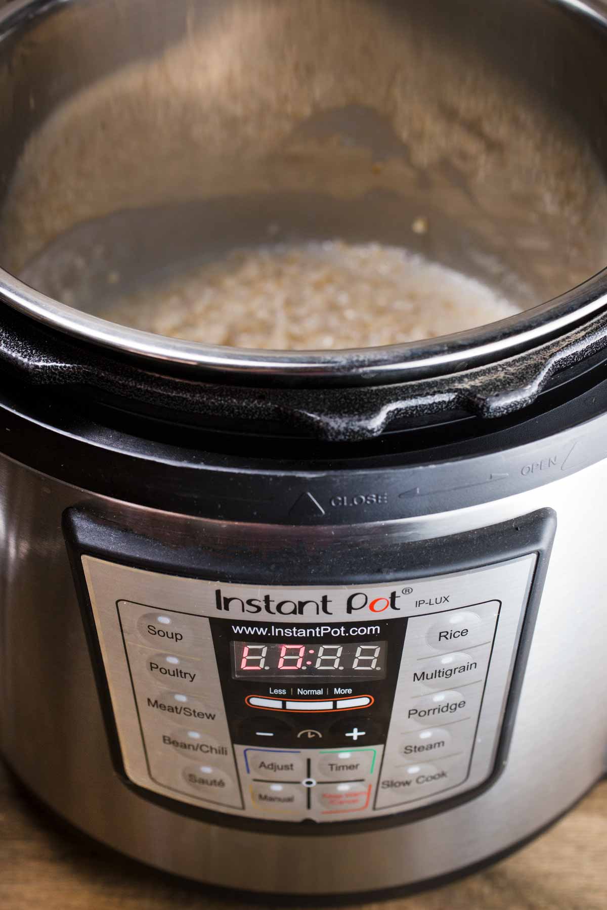 Front view of an instant pot, full of steel cut oatmeal.