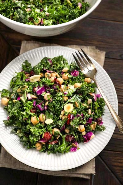 Kale Salad with cranberries on a white plate