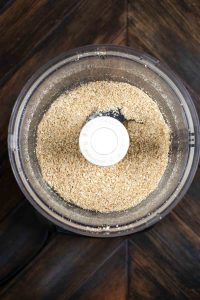 Mixture of oats, flax seed and shredded coconut in a food processor