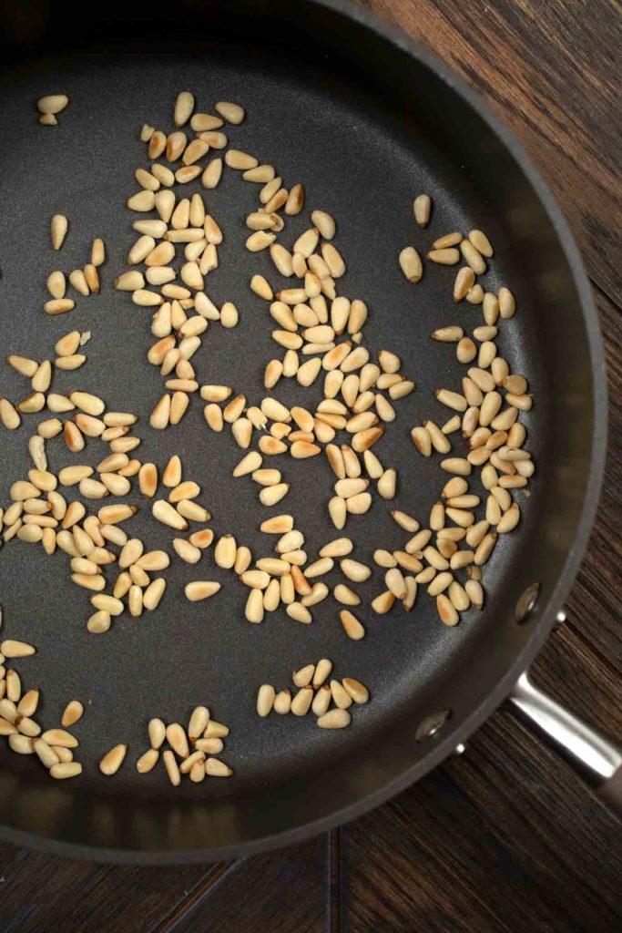 A skillet with toasted pine nuts. 