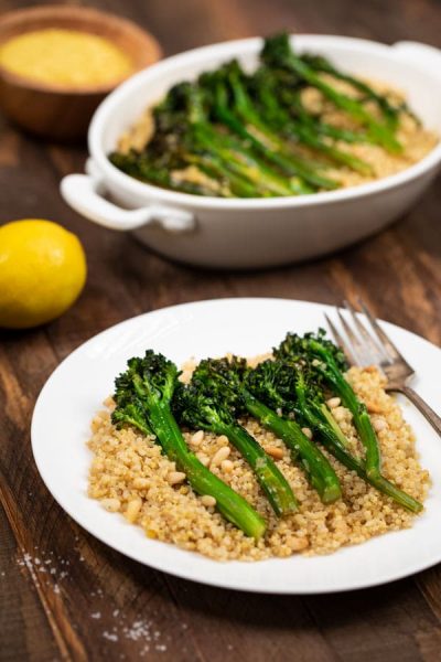 Plates of Charred Broccolini with Garlic and Quinoa with lemon on the side