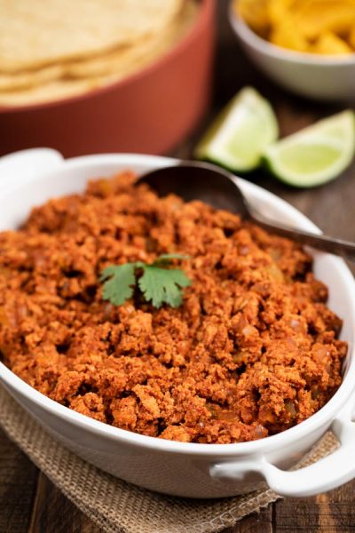 Vegan Homemade soy chorizo recipe in a white bowl with a spoon