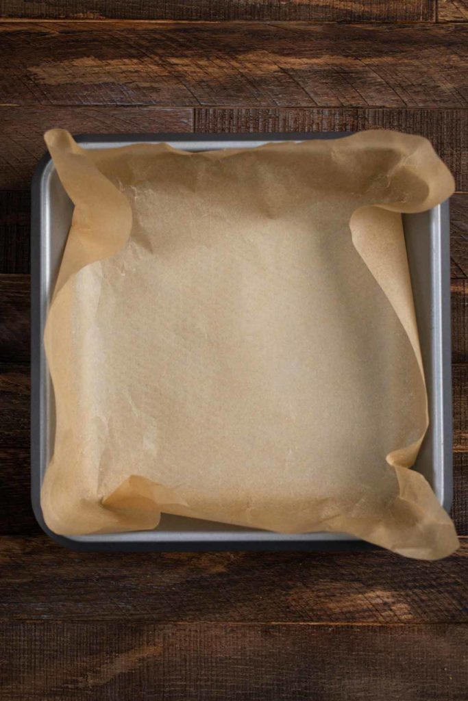 An aluminum baking pan covered in parchment paper. 