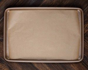 A baking pan covered with parchment paper.