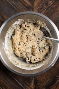 Muffin batter with blueberries mixed in