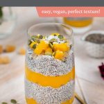 A mango chia seed pudding in a glass with pumpkin seeds and a spoon.